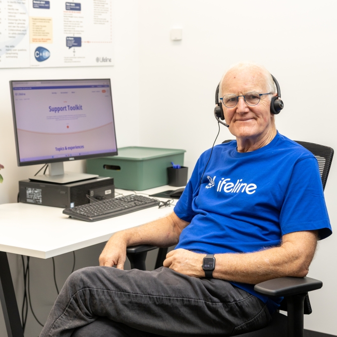Lifeline crisis supporter in headset looking at camera