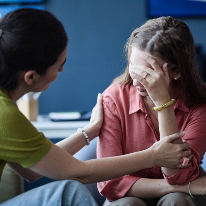Woman comforting woman